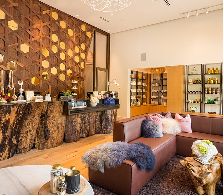 Viva Day Spa + Med Spa Domain Northside's lobby welcomes guests with a sophisticated fusion of warm natural elements and modern spa and skin care retail selections.