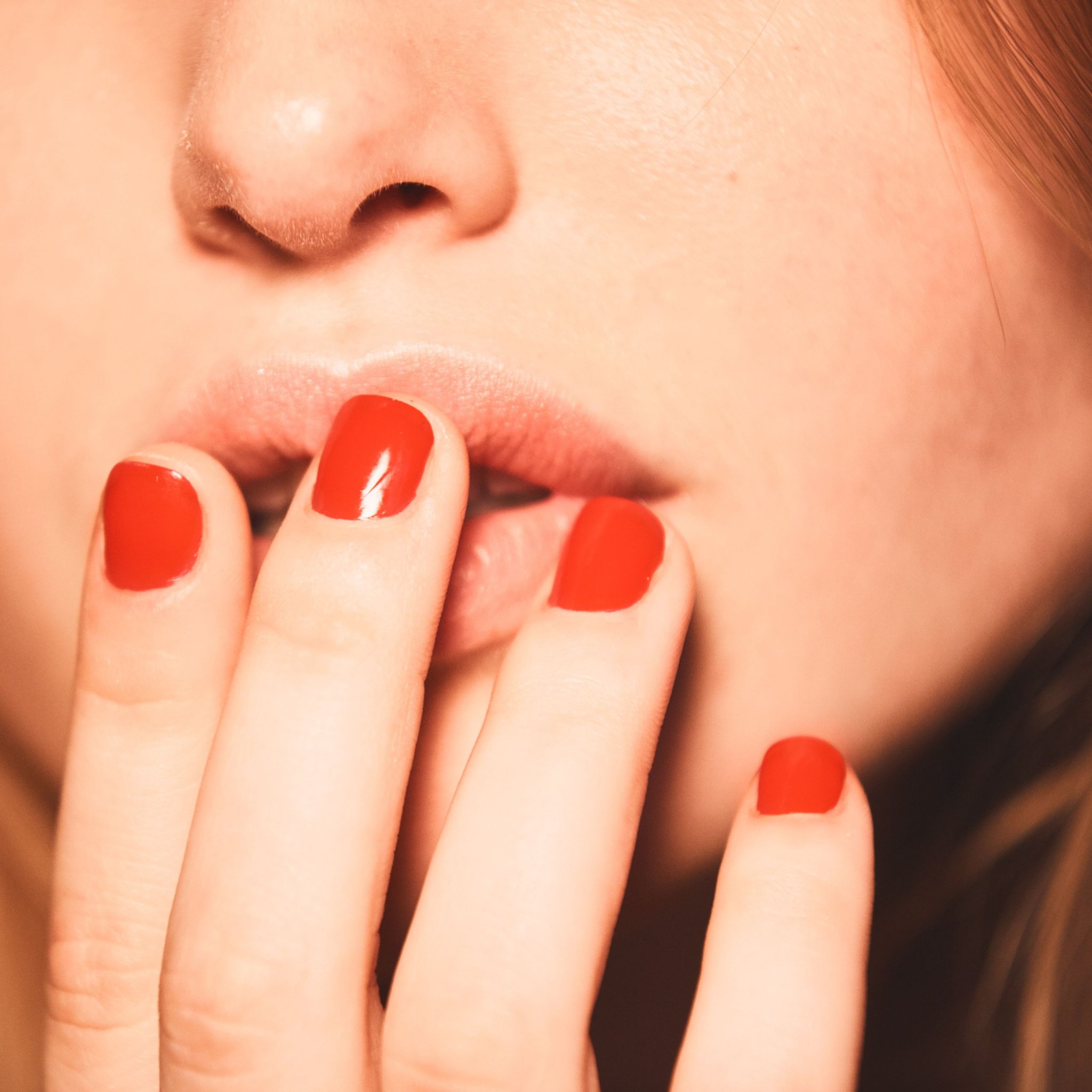 red nails over lips