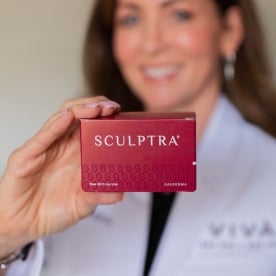 Sculptra injectable product box held by Mandy Ward, FNP-BC, aesthetic nurse practitioner at Viva Day Spa + Med Spa in Dallas.