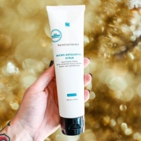 Hand holding SkinCeuticals Micro-Exfoliating Scrub available at Viva Day Spa + Med Spa in Austin, Round Rock, and Dallas, TX
