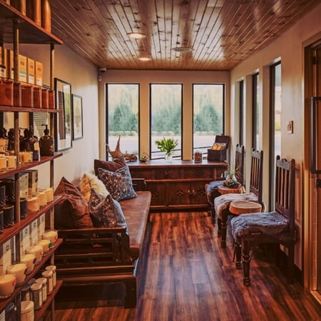 Sun-filled lobby with warm wood tones, cozy seating and spa retail displays at Viva Day Spa + Med Spa on West 35th Street in Austin, TX