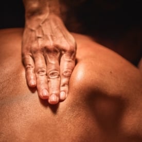 Massage therapist's hands working on a guest's back during a relaxing massage treatment at Viva Day Spa + Med Spa in Austin, Dallas, and Round Rock, Texas