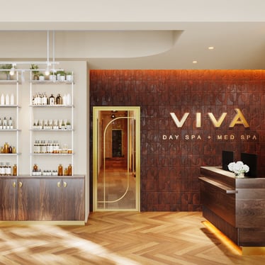 The lobby at Viva Day Spa + Med Spa Morningside in Atlanta, GA, welcomes guests with warm wood finishes, a gold-framed glass door, and professional skin care product displays.
